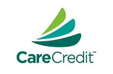 The CareCredit logo featuring three stylized, overlapping leaf-like shapes in shades of green above the text 