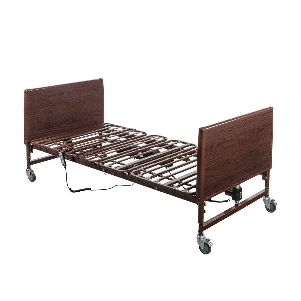 An adjustable hospital bed with a metal wire frame and brown wooden headboard and footboard on rolling casters.