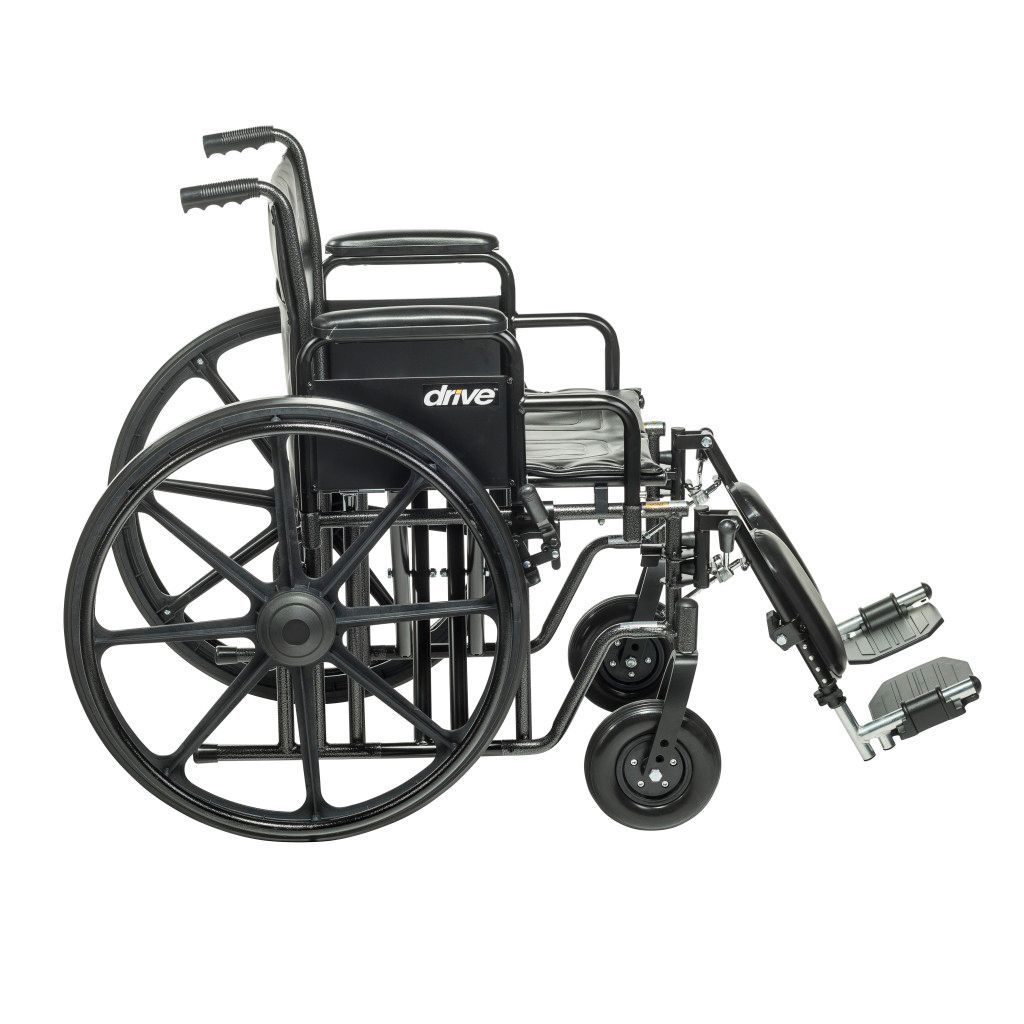 A black, folding, manual wheelchair with large rear wheels and adjustable leg rests against a white background.