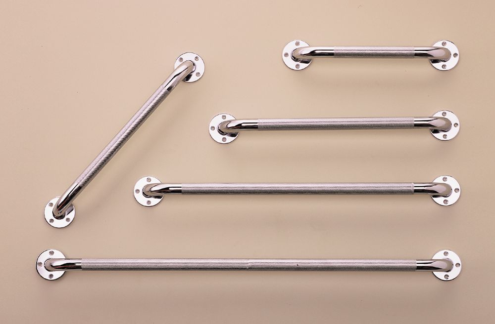 Set of shiny metal grab bars arranged diagonally on a beige background