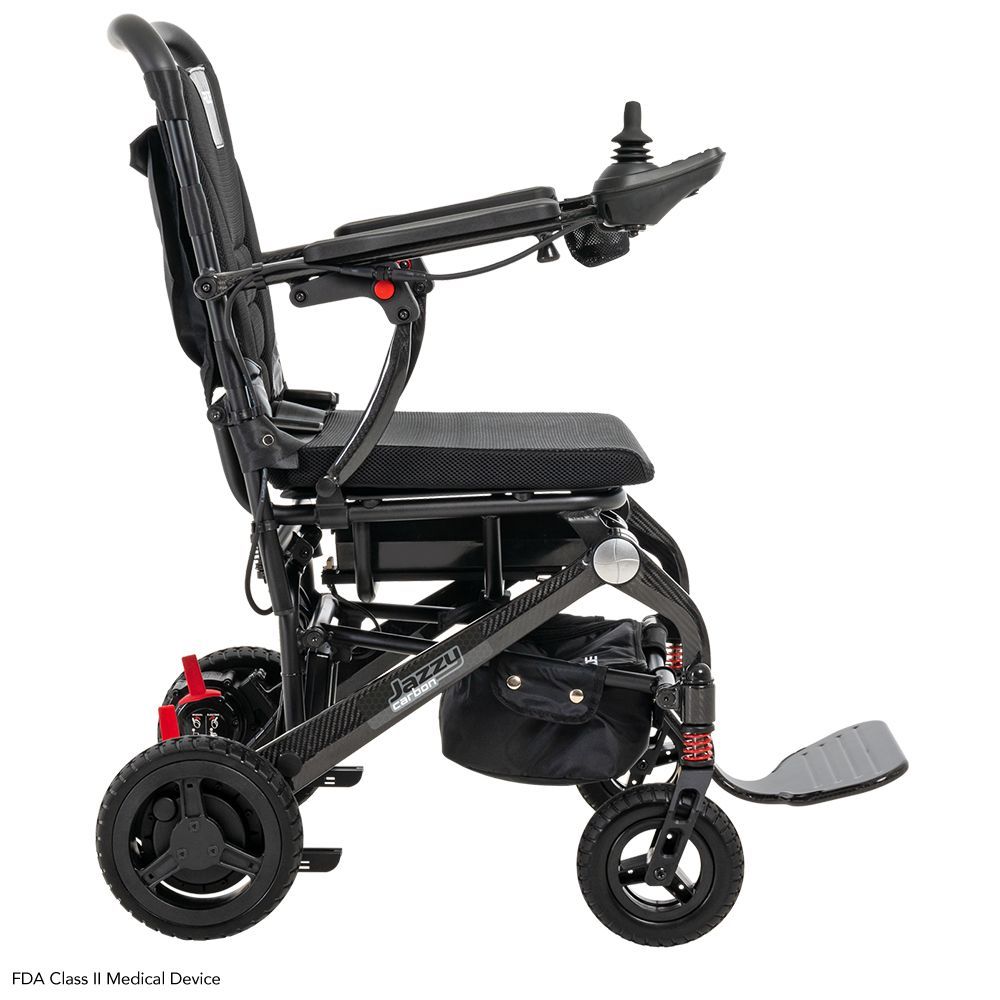 A black foldable power wheelchair with a joystick controller and footrest, viewed from the side on a white background.