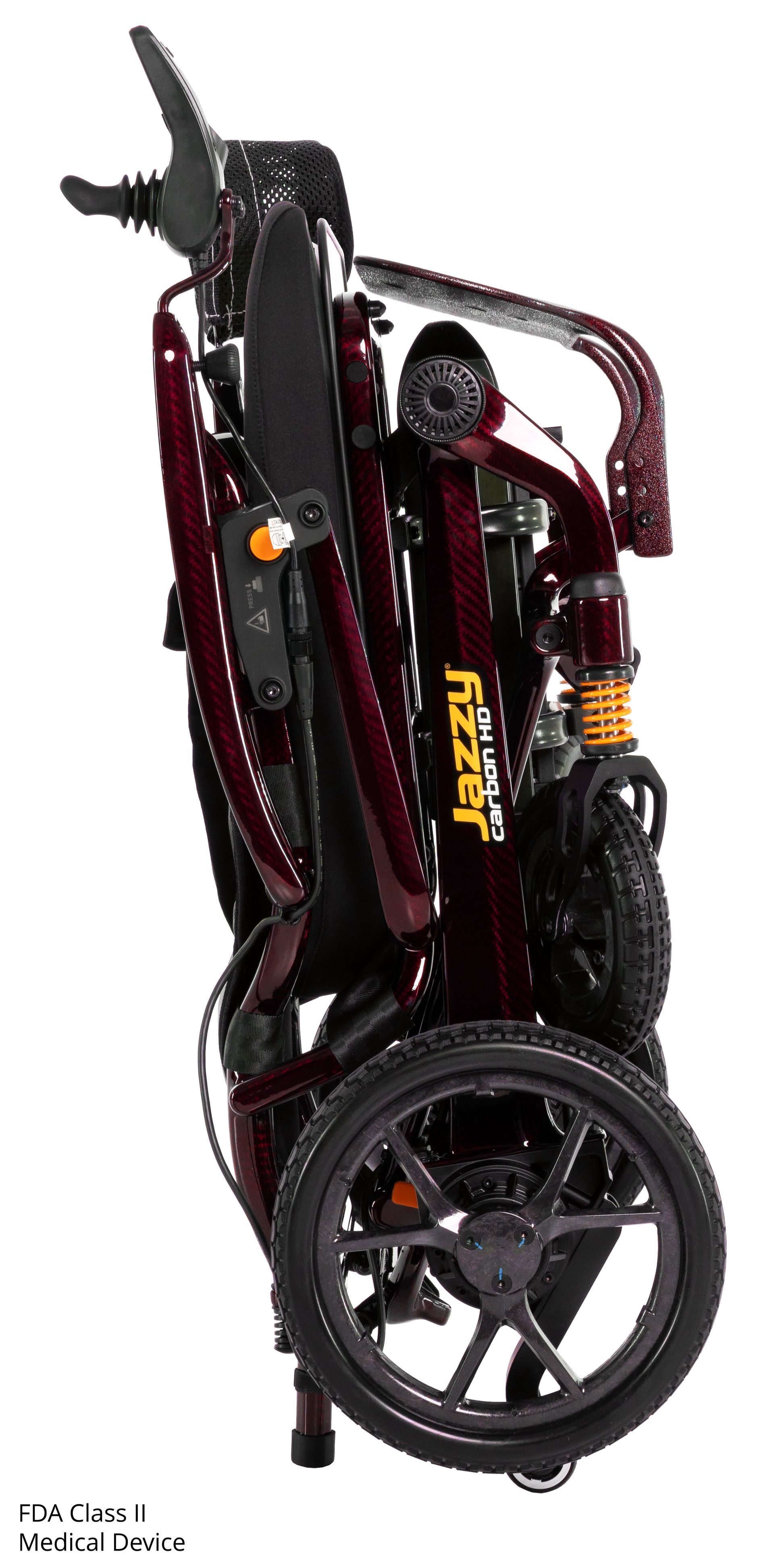 A maroon Jazzy Passport folding power wheelchair with a black seat and joystick controller on a white background.