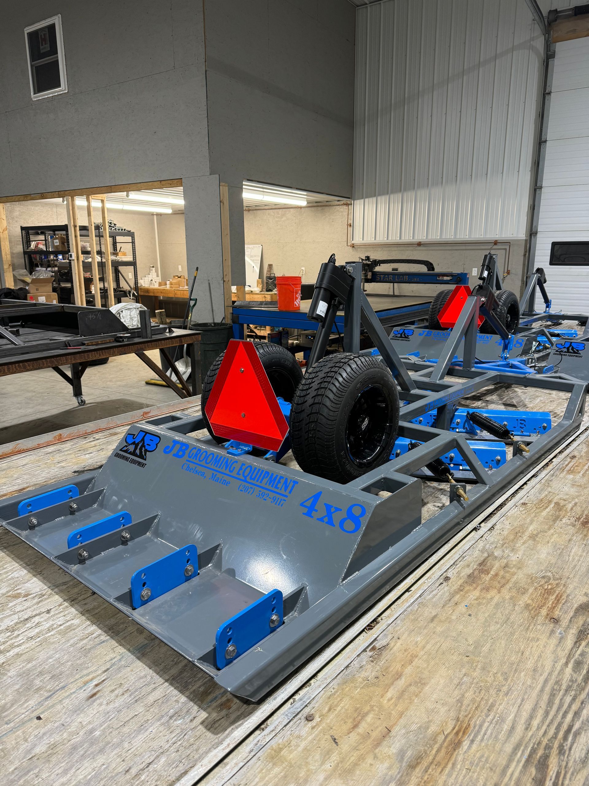A machine is sitting on top of a wooden table in a warehouse.