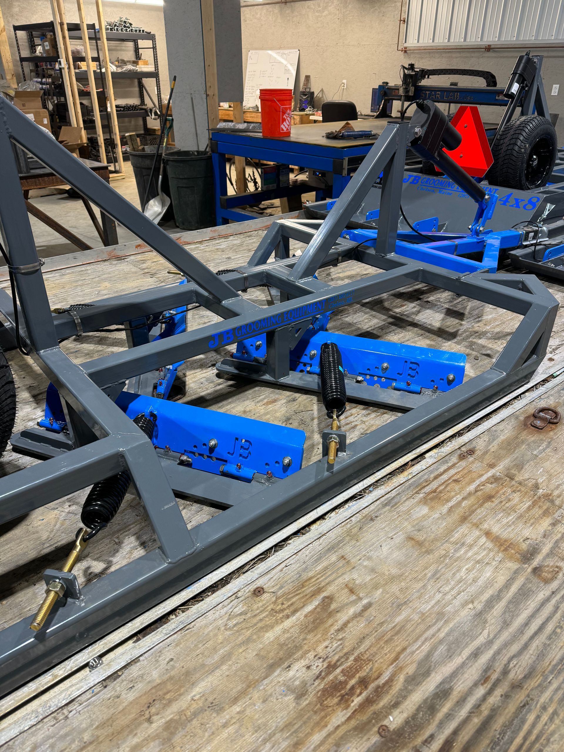 A metal frame is sitting on top of a wooden table.