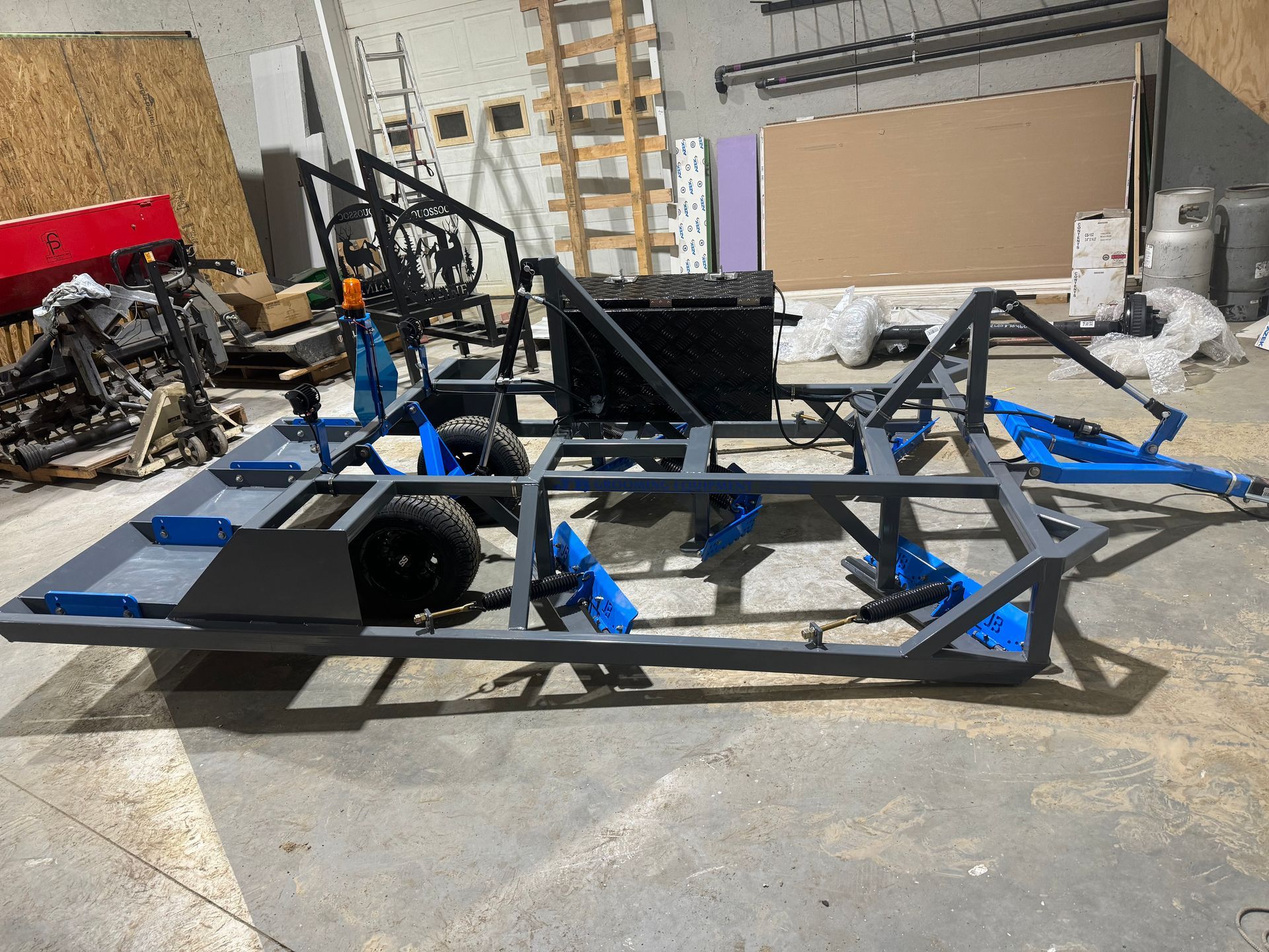 A trailer is sitting on the ground in a warehouse.
