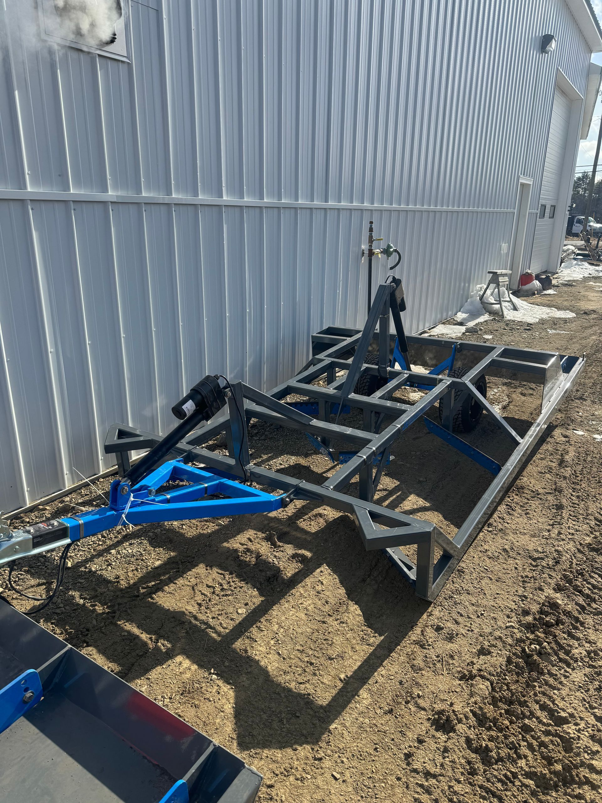 A trailer is sitting on the ground in front of a building.