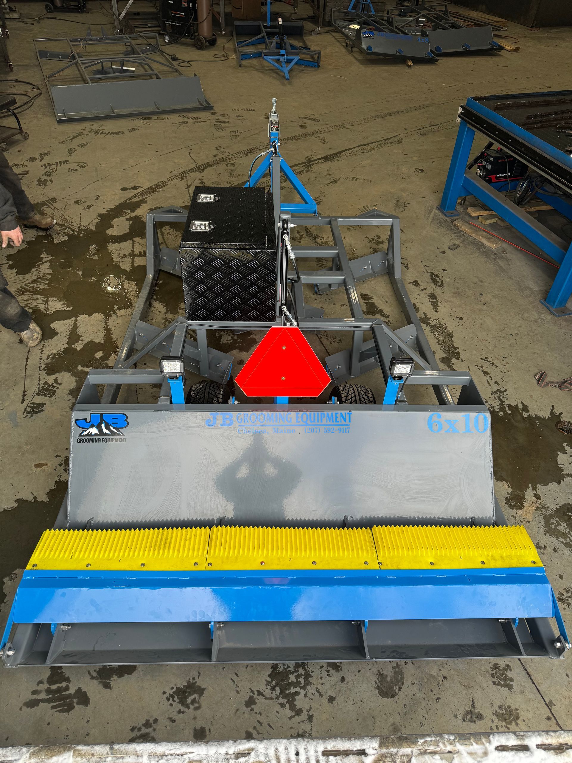 A blue and yellow machine with a red triangle on it