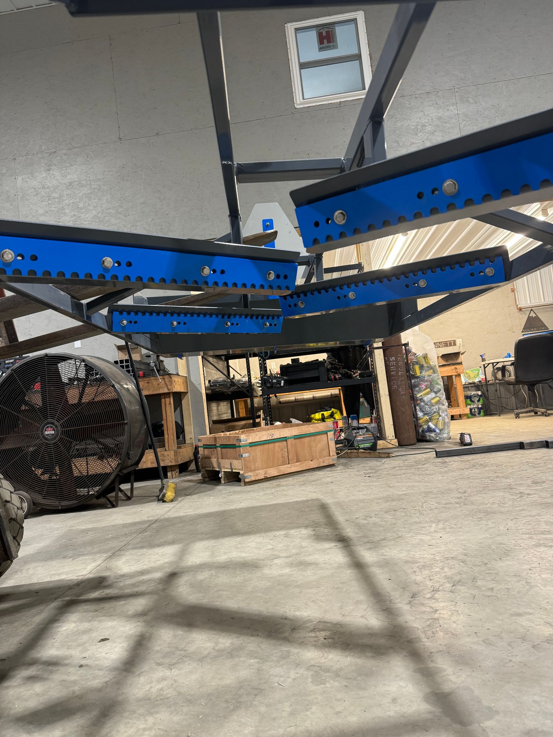 A large metal structure is sitting in a garage.