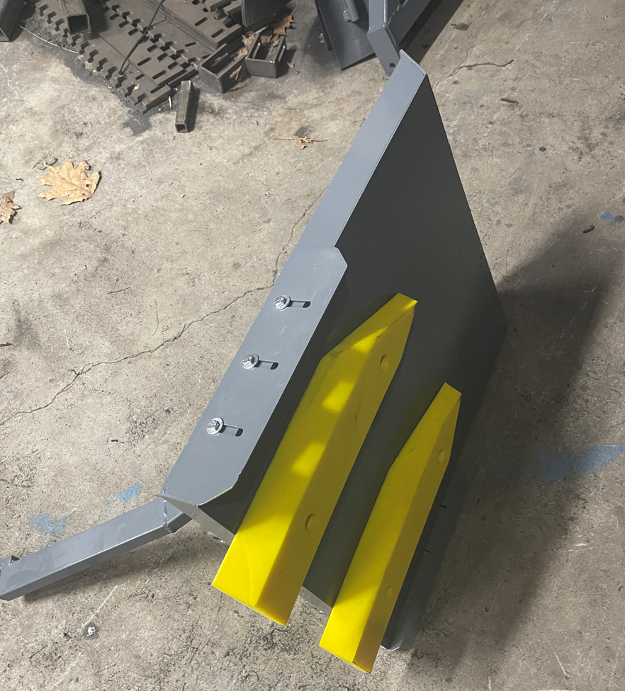 A piece of metal with yellow pieces attached to it
