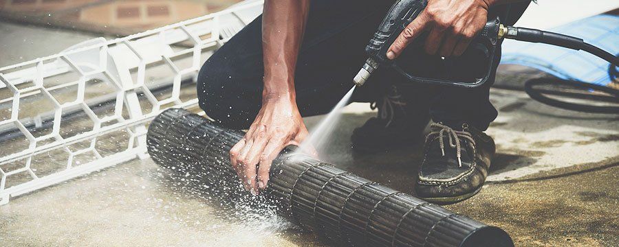 Man Cleaning The Air Conditioner Filters — Georgetown, TX — Roger Stuth AC