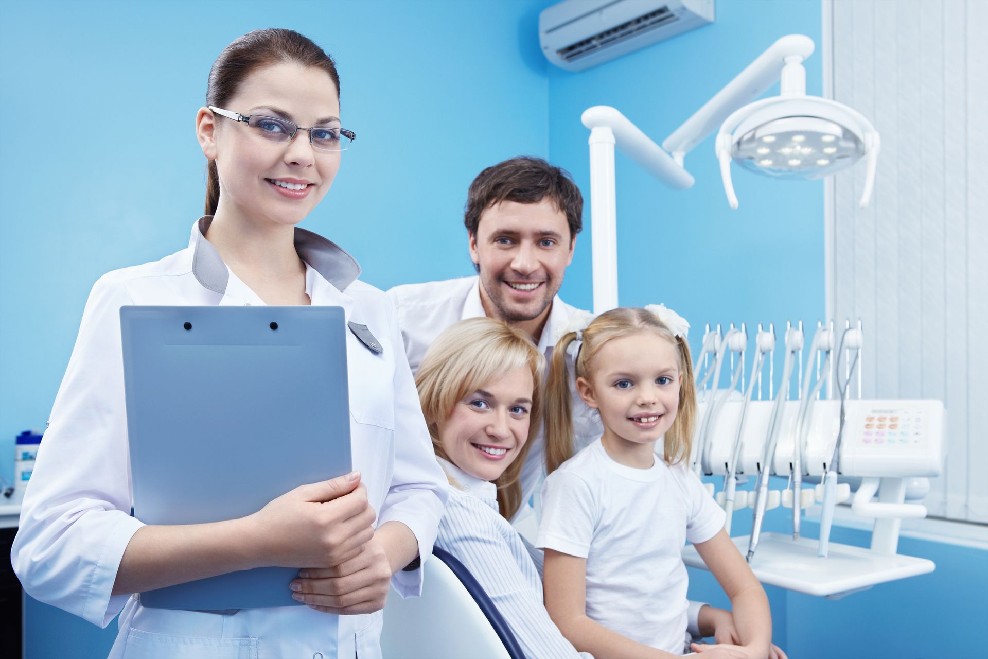 Family dental checkup with dentist in clinic, showing patient care and professional equipment.