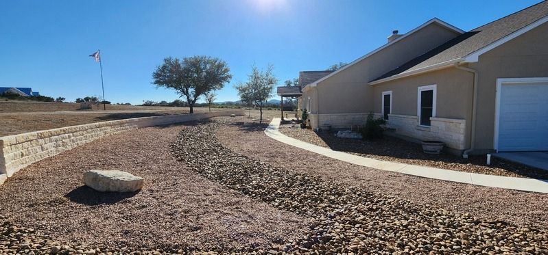 Rock-covered front yard with a curved path