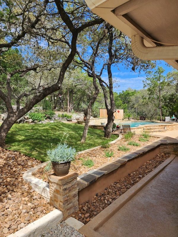 Shaded backyard patio with trees