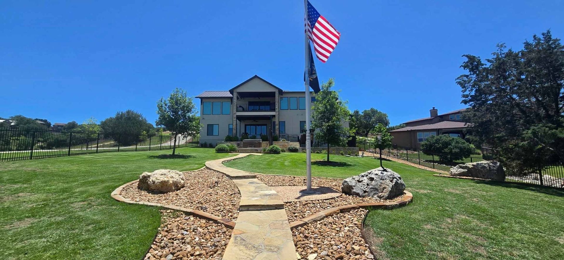 Sunny suburban yard with an American flag