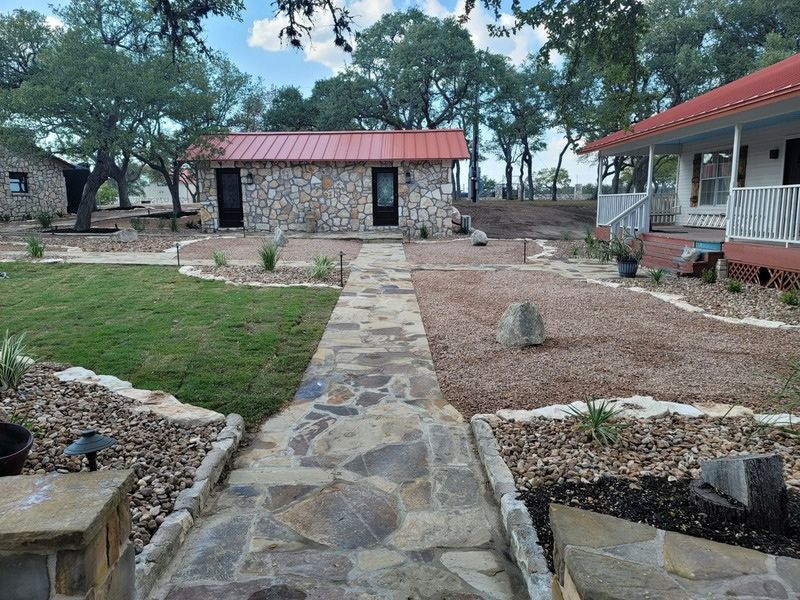 Stone walkway leading to a small stone house