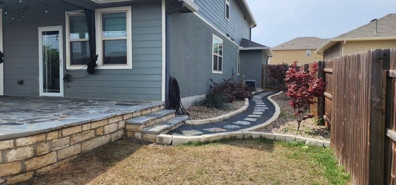 Backyard patio with curved stone walkway