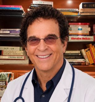 A man in a black shirt is smiling for the camera.