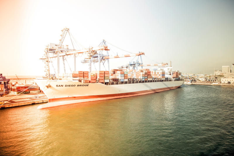A large container ship is floating on top of a body of water.