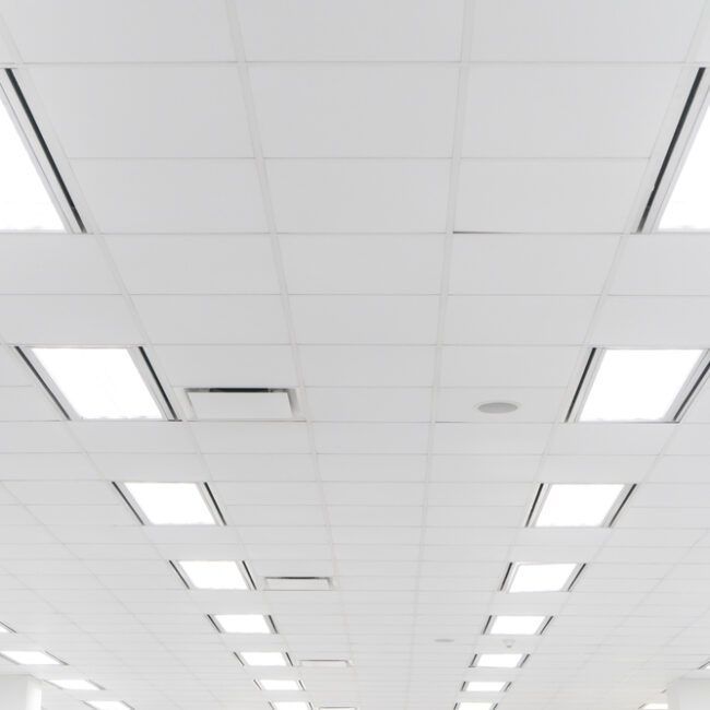 White office ceiling with recessed square lights.