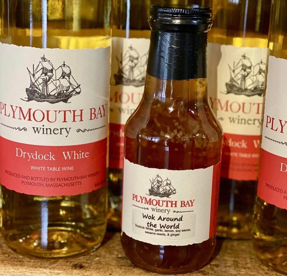 Bottles of white wine and a brown sauce bottle with labels from Plymouth Bay Winery.