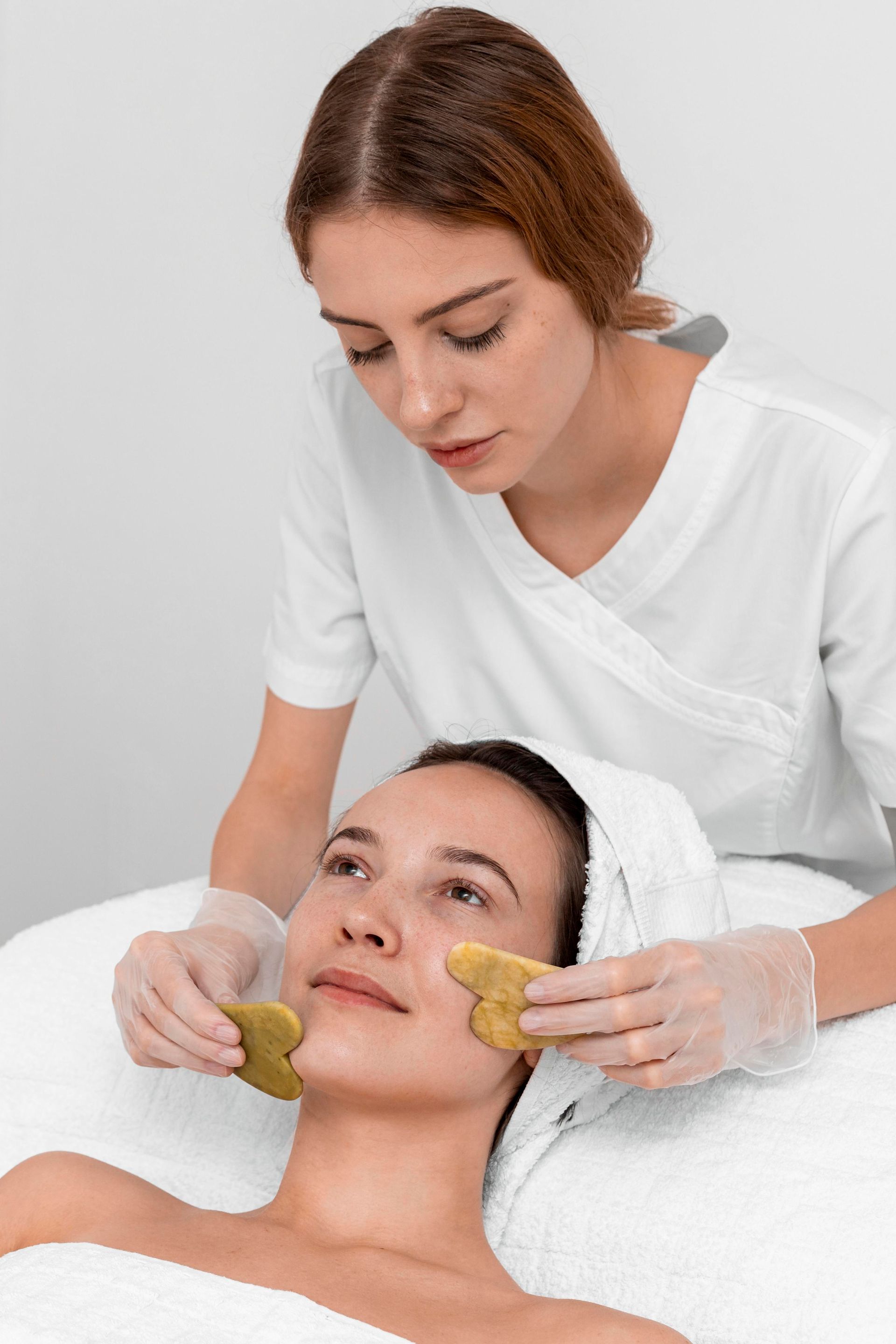 A woman is getting a facial treatment at a spa.