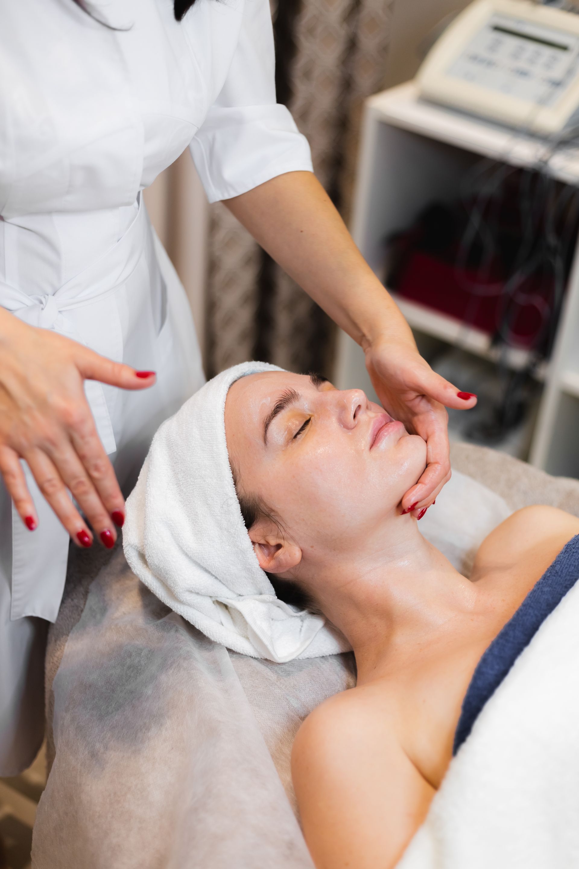 A woman is getting a facial treatment at a spa.