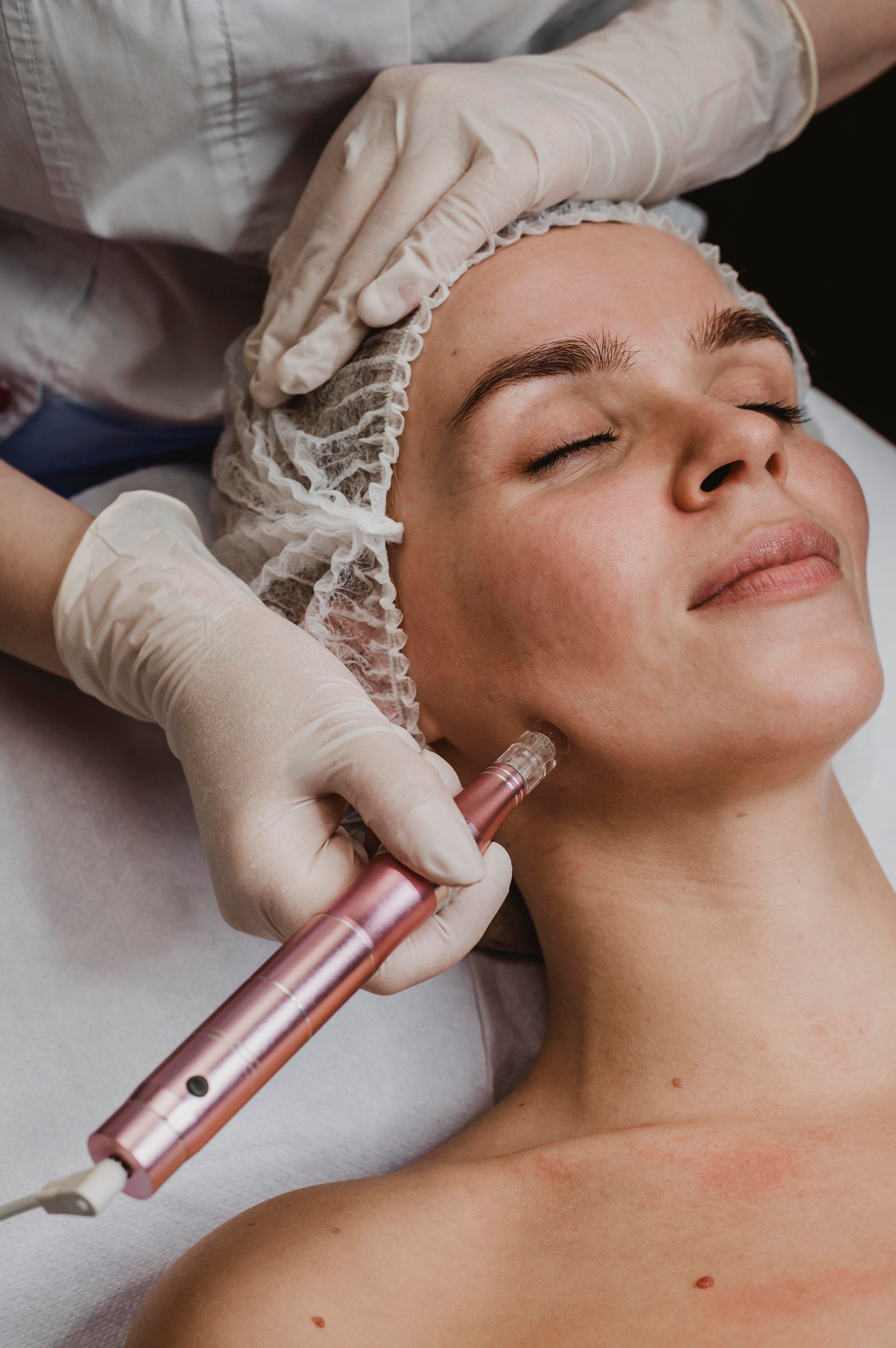A woman is getting a facial treatment at a beauty salon.