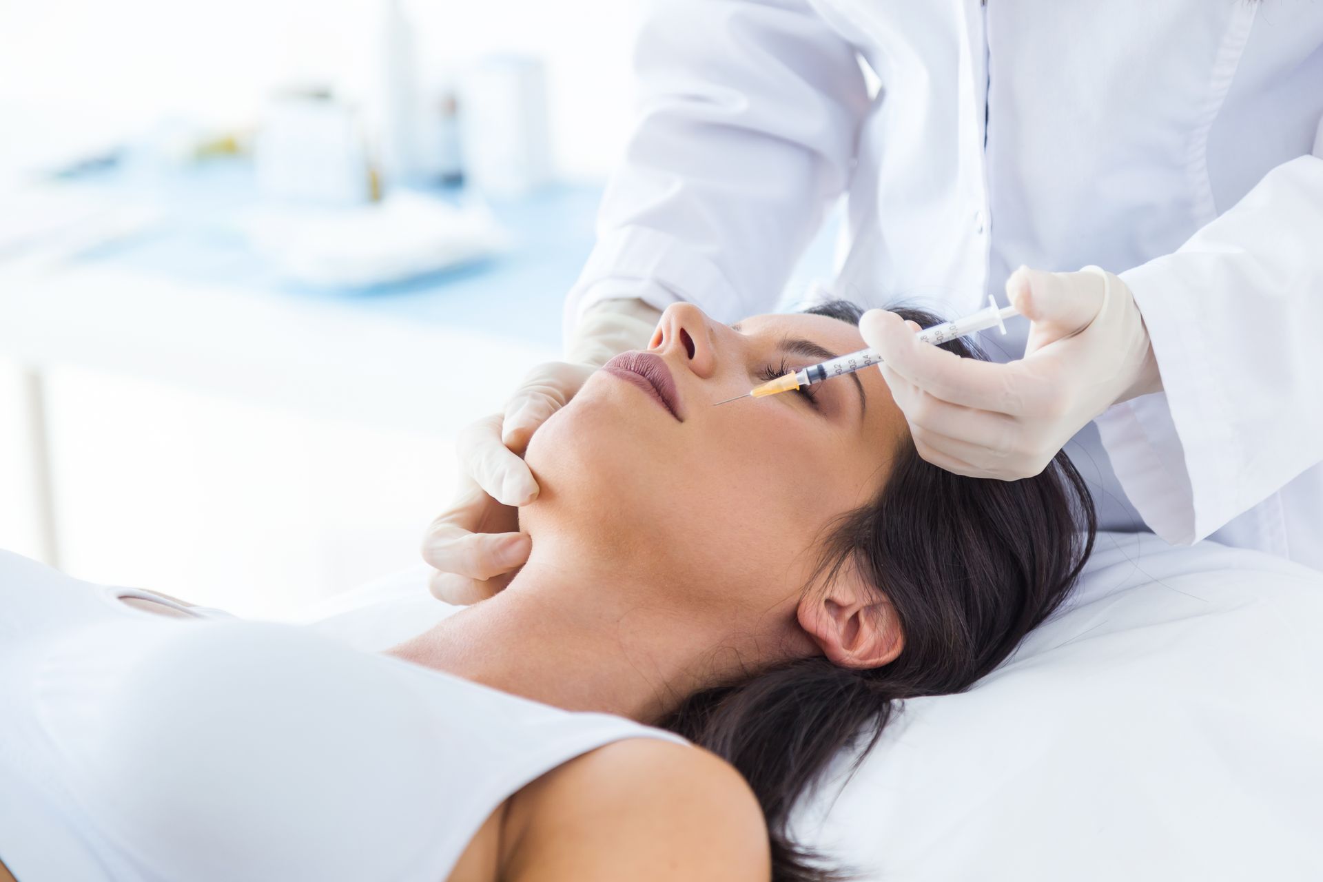 A woman is getting an injection in her eye.