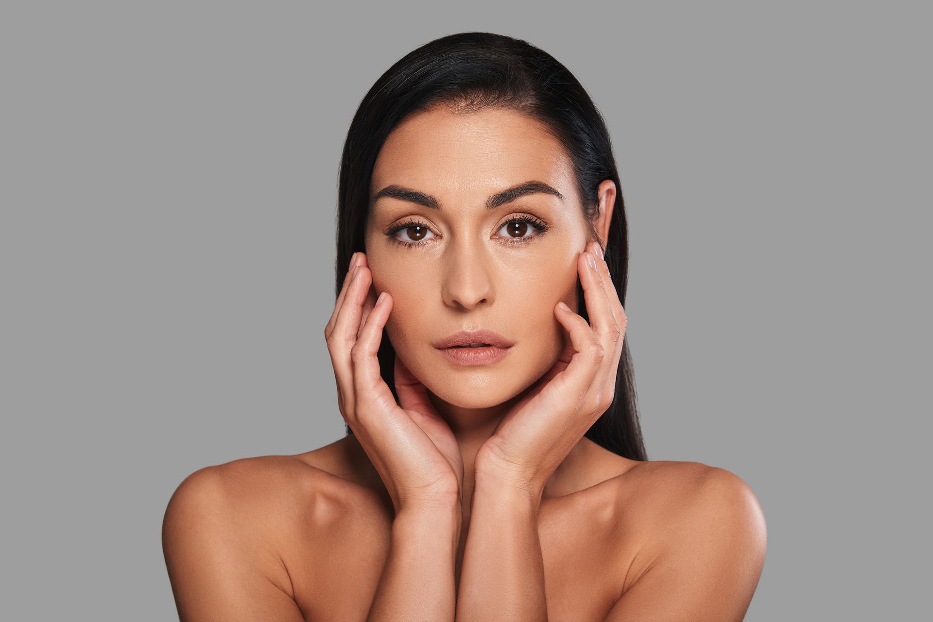A woman touching her face