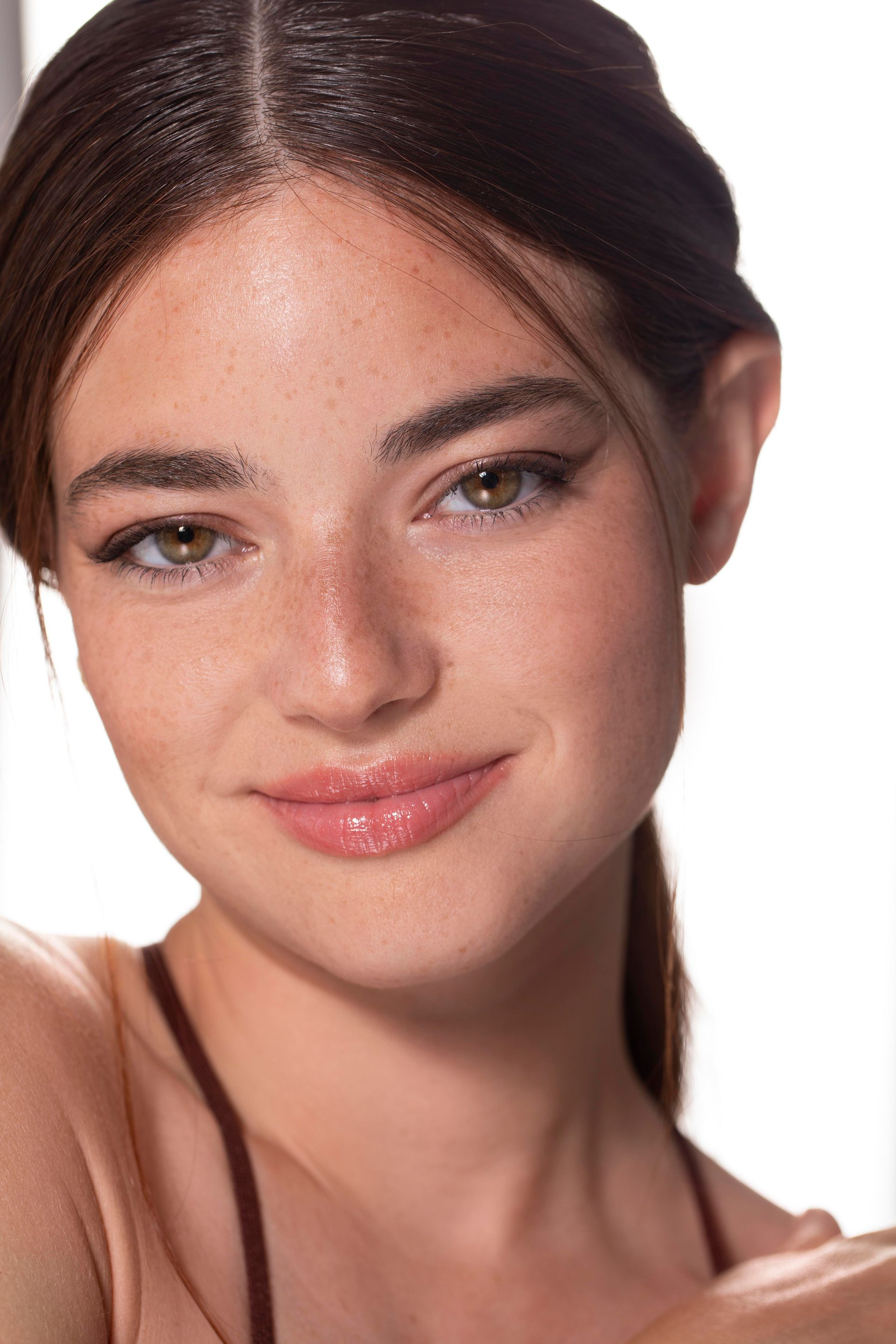A close up of a woman 's face with a white background