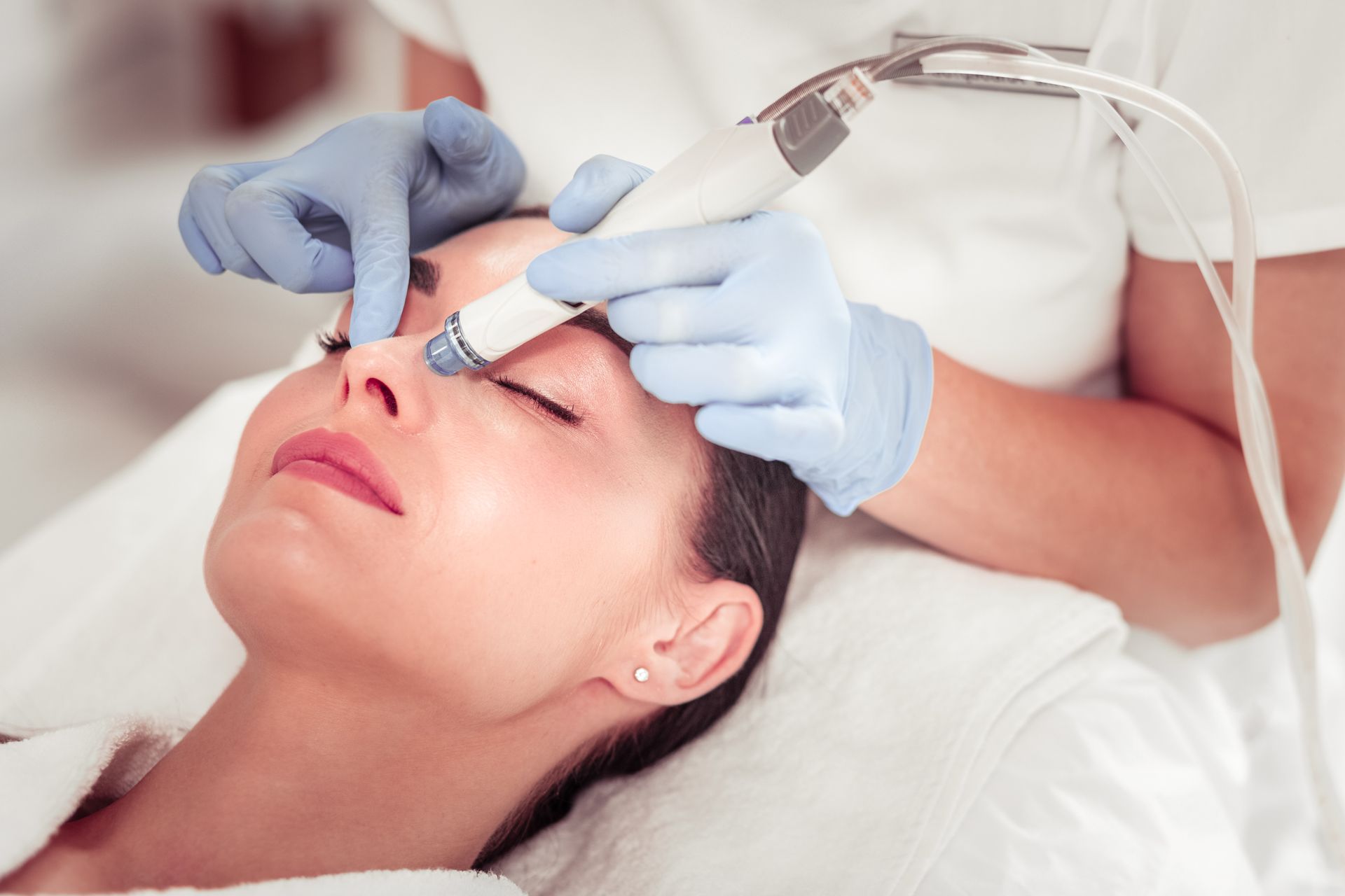 A woman is getting a facial treatment at a beauty salon.