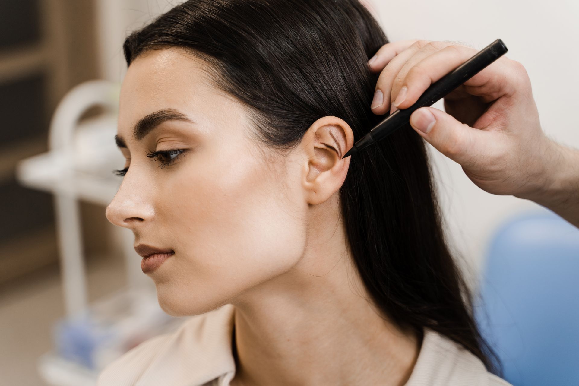A woman is getting her hair done by a hairdresser in a salon.