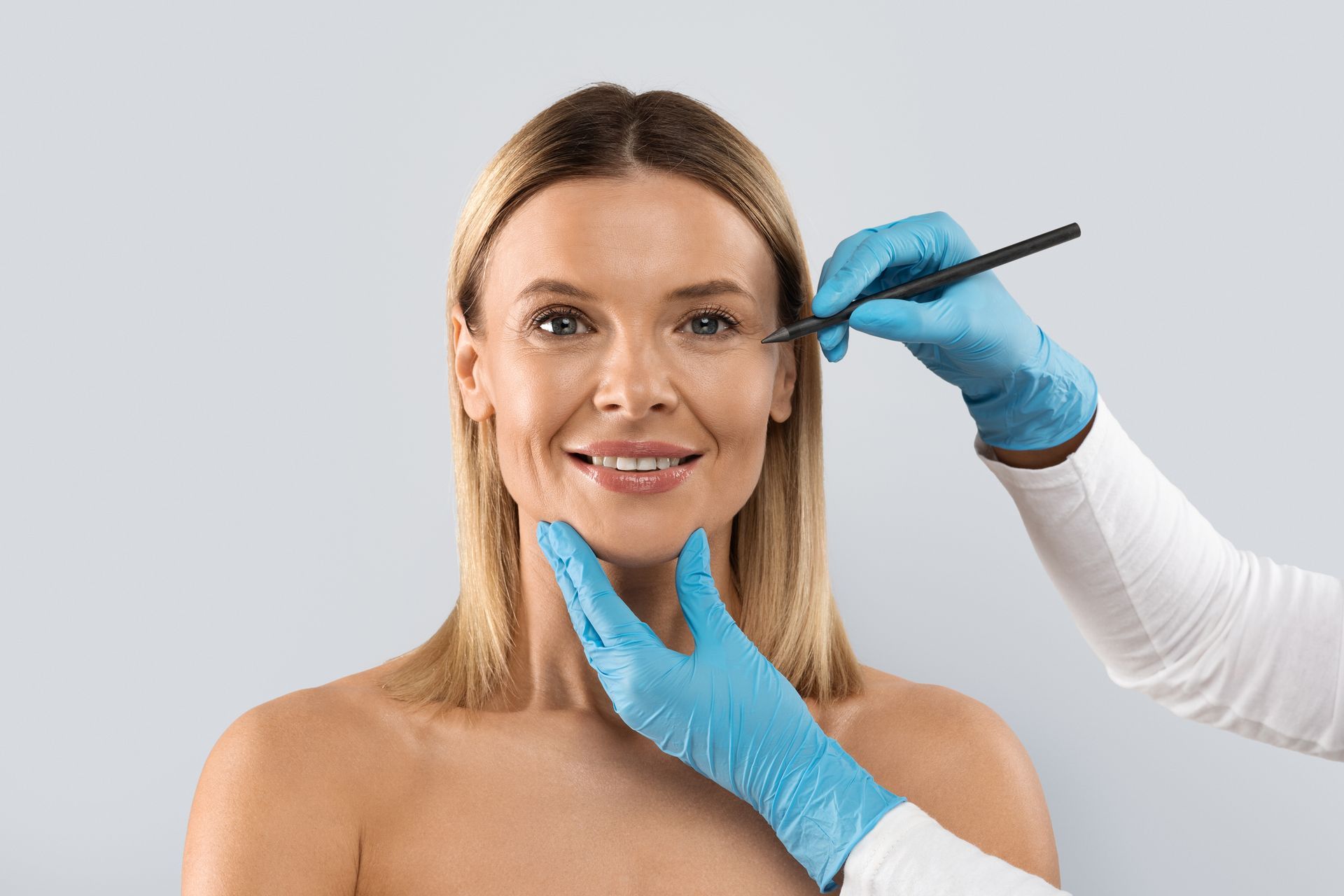 A woman is getting a cosmetic procedure on her face.
