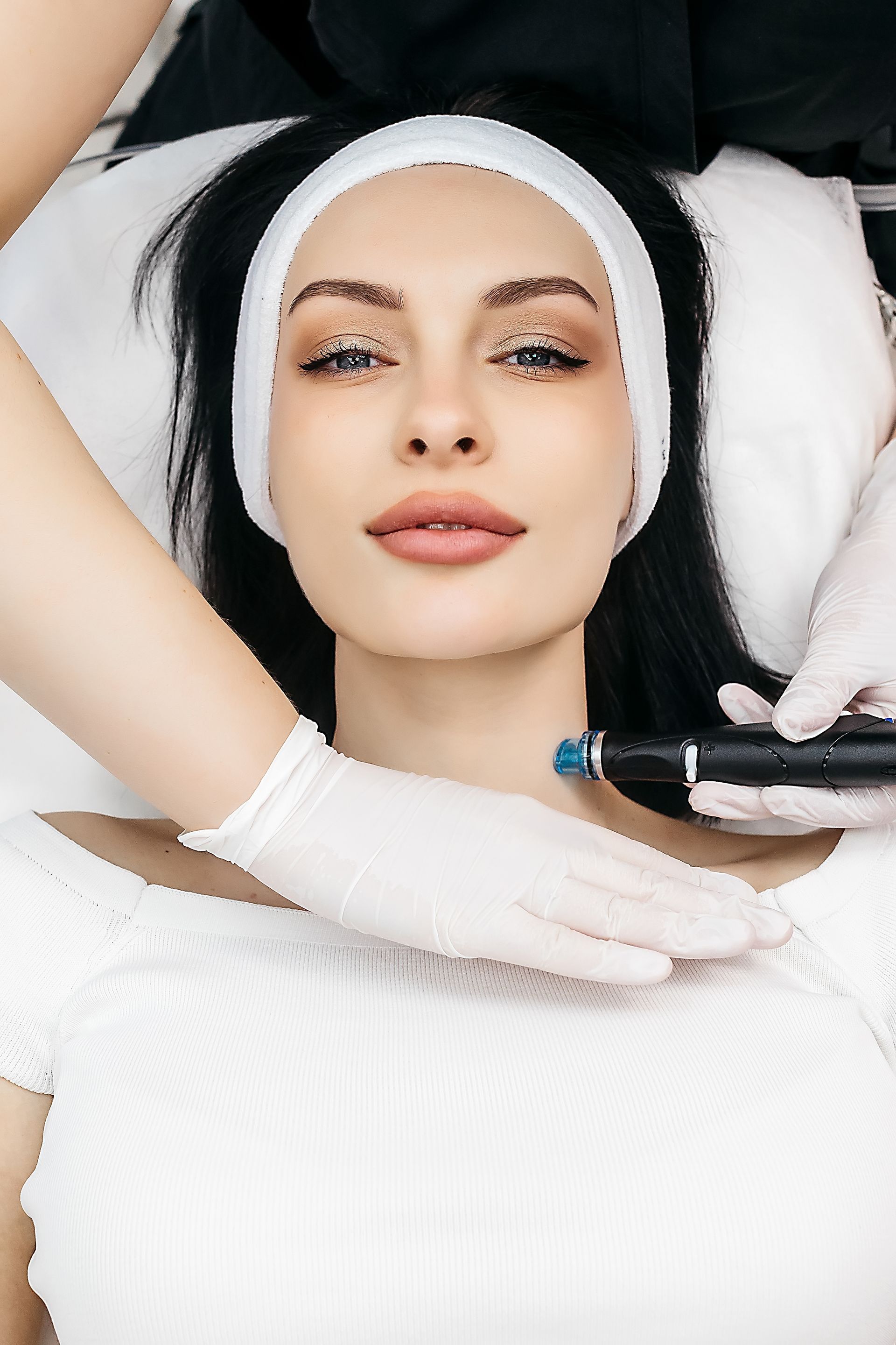 A woman is getting a facial treatment in a beauty salon.