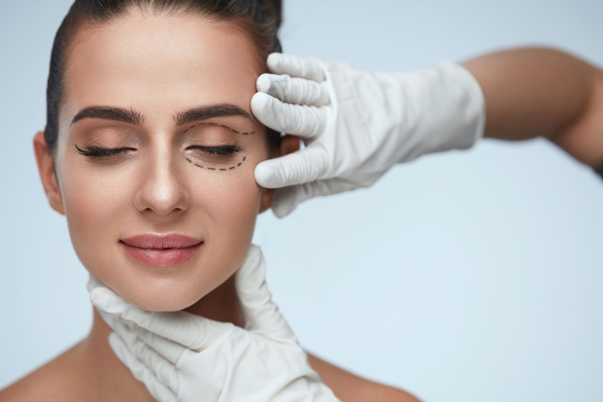 A woman is getting a cosmetic procedure on her eye.