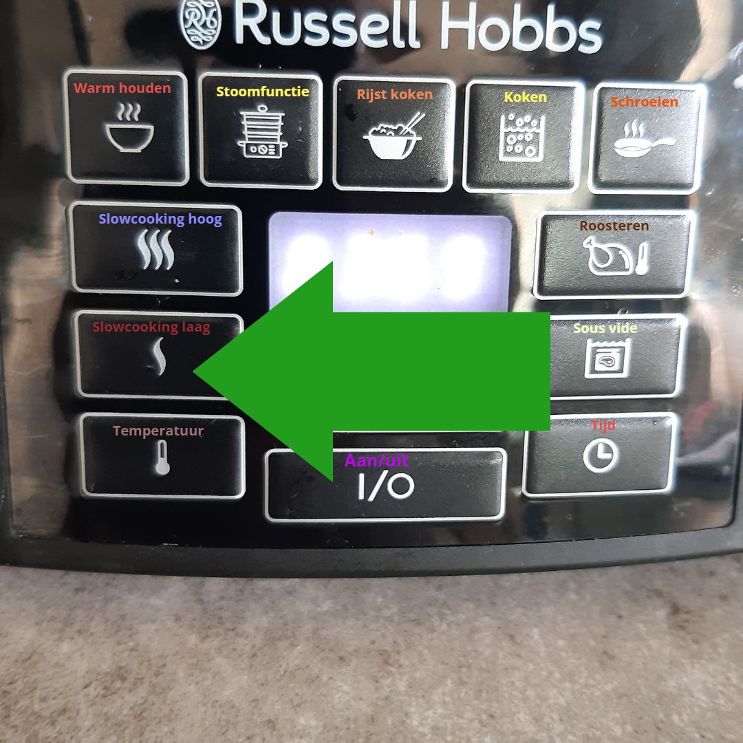 Een bedieningspaneel van een Russell Hobbs-apparaat met een groene pijl die naar de