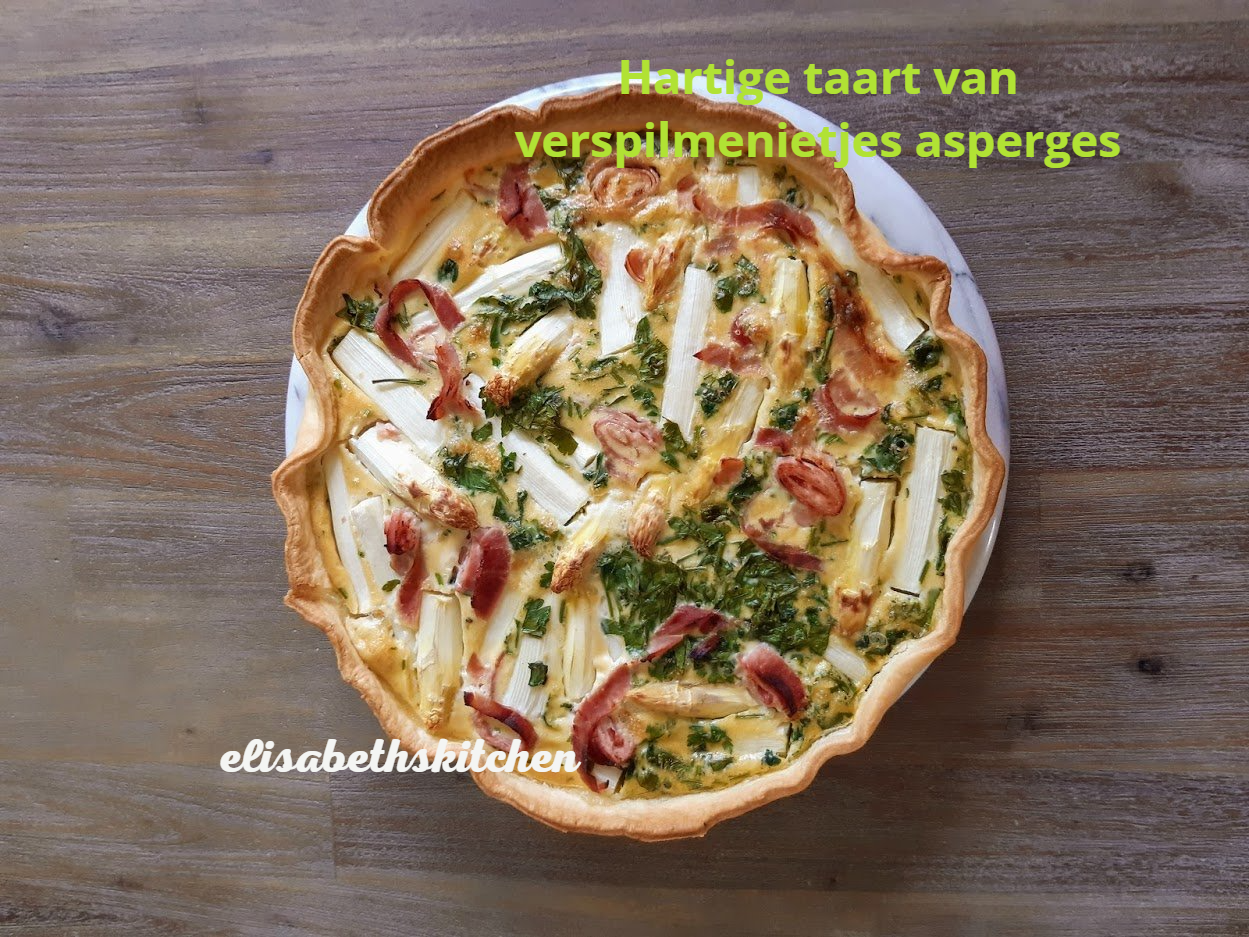 Asparagus tart on a white plate, set on a wooden surface. Text: