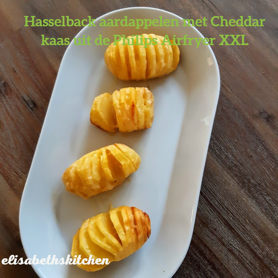 Hasselback-aardappelen met cheddar kaas uit de airfryer. Close-up op een wit bord.