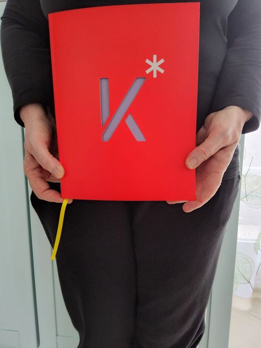 Klik op de foto en je komt op de site om het boek te bestellen Persoon houdt een rood boek vast met een uitgesneden