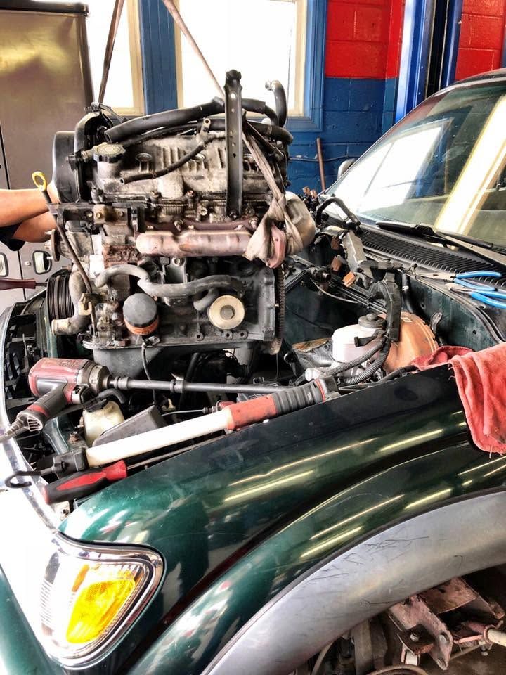 Engine Repair Work On A Green Vehicle | Elmwood Certified Powered by Ampro Auto