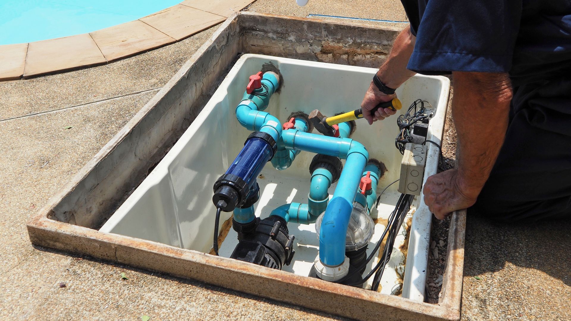 Person Working on Pool Plumbing Inside a Concrete Box — Ballina Leak Detection & Swimming Pool Repairs in Ballina, NSW