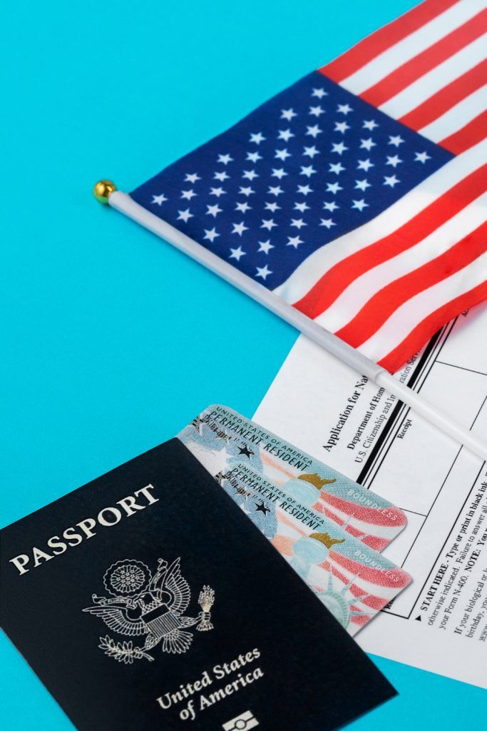 US passport and two ID cards with American flag on blue background.