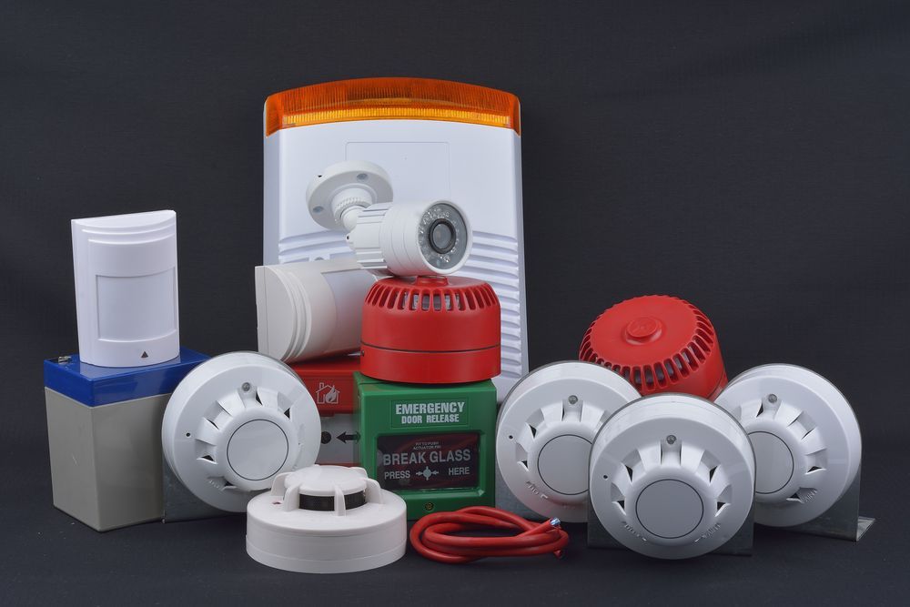 A Bunch of Fire Alarms Are Sitting on Top of Each Other on a Table — Adept Security In Oak Flats, NSW