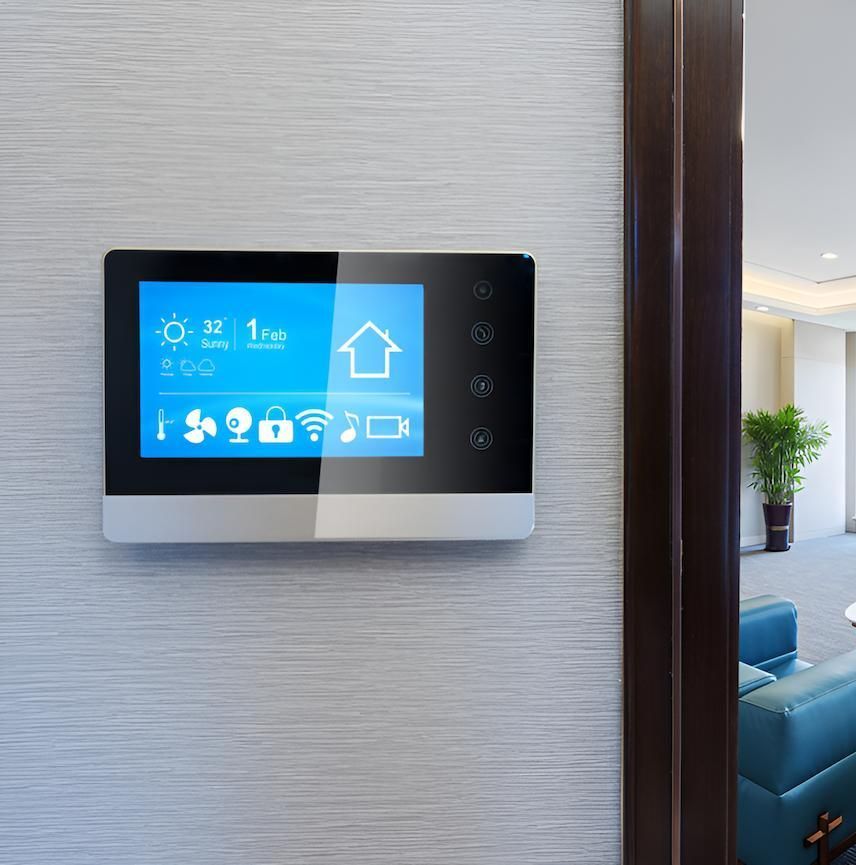 A Thermostat is Mounted on a Wall Next to a Door — Adept Security In Dapto, NSW