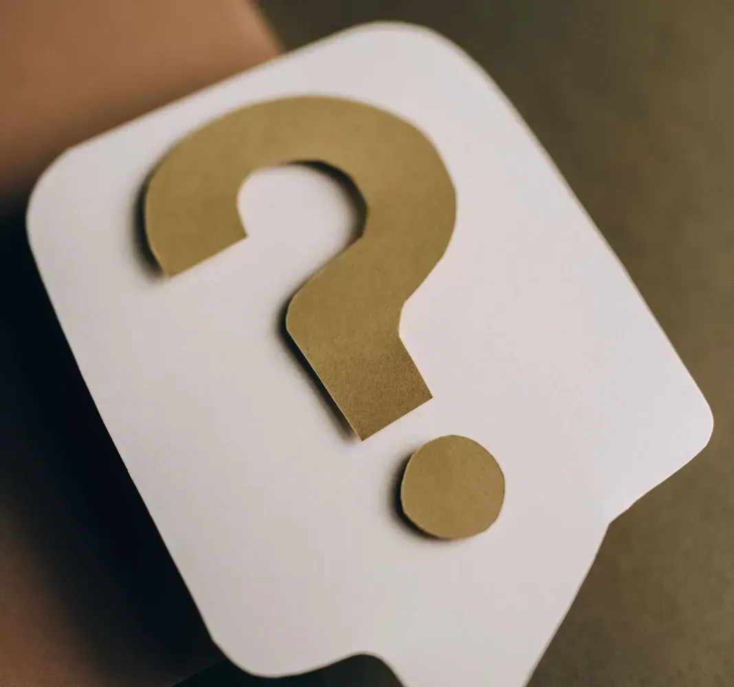 White speech bubble with a gold question mark on a dark background