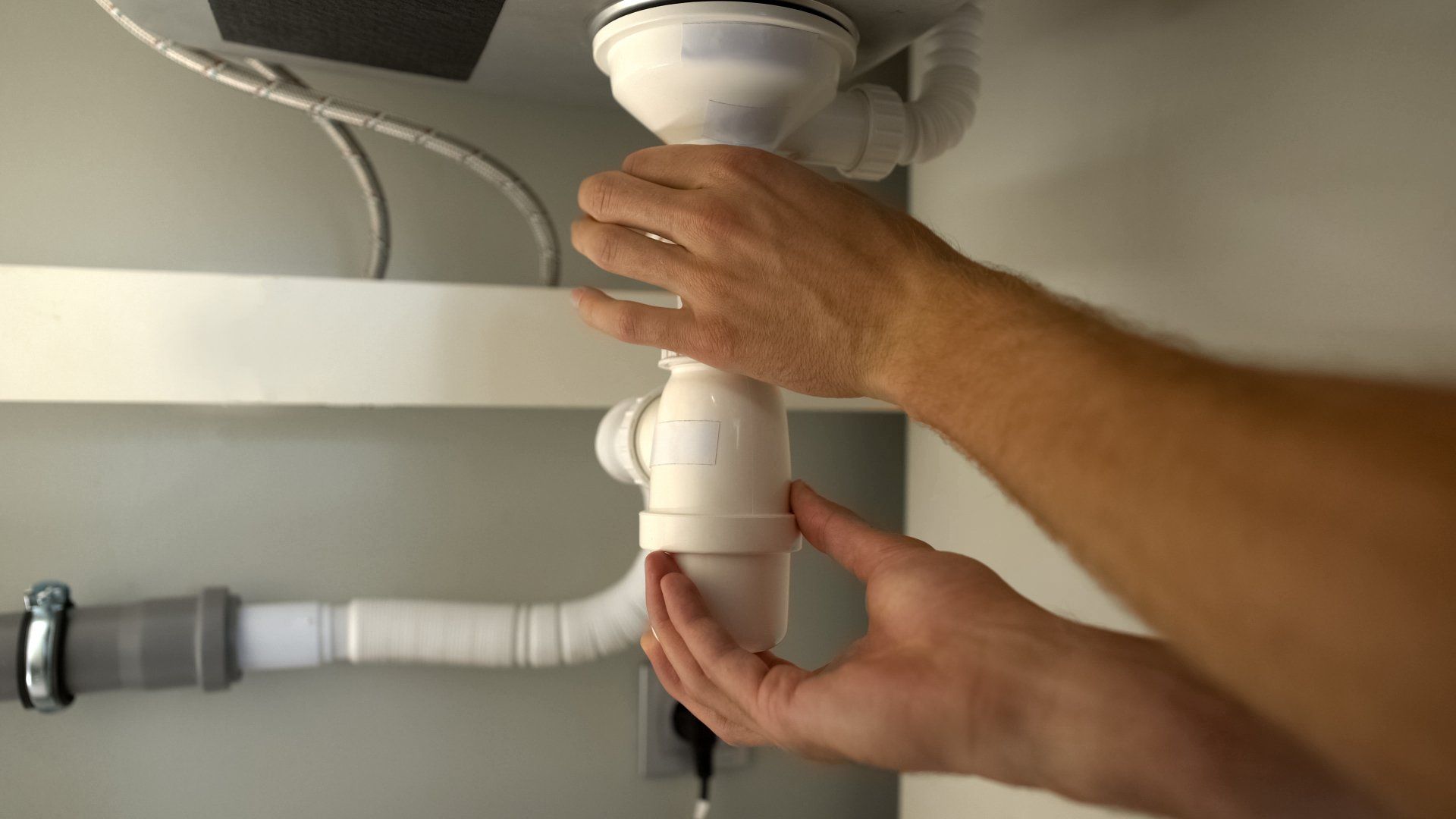 Male Hand Checking Clogged Water Pipes - Baynton, WA - NWS Plumbing and Gas