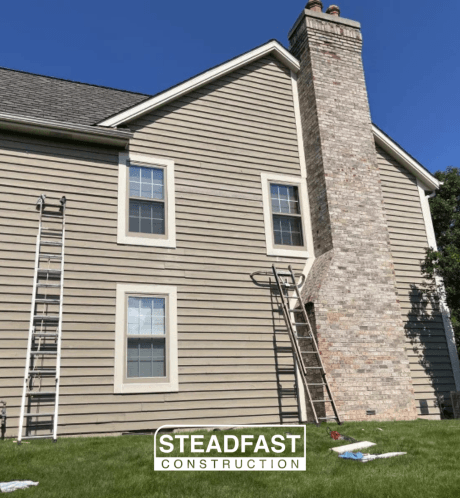 A house is being resided by steadfast construction