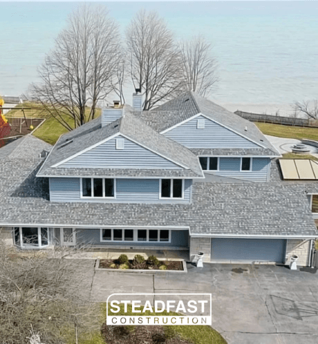 An aerial view of a large house with a gray roof.