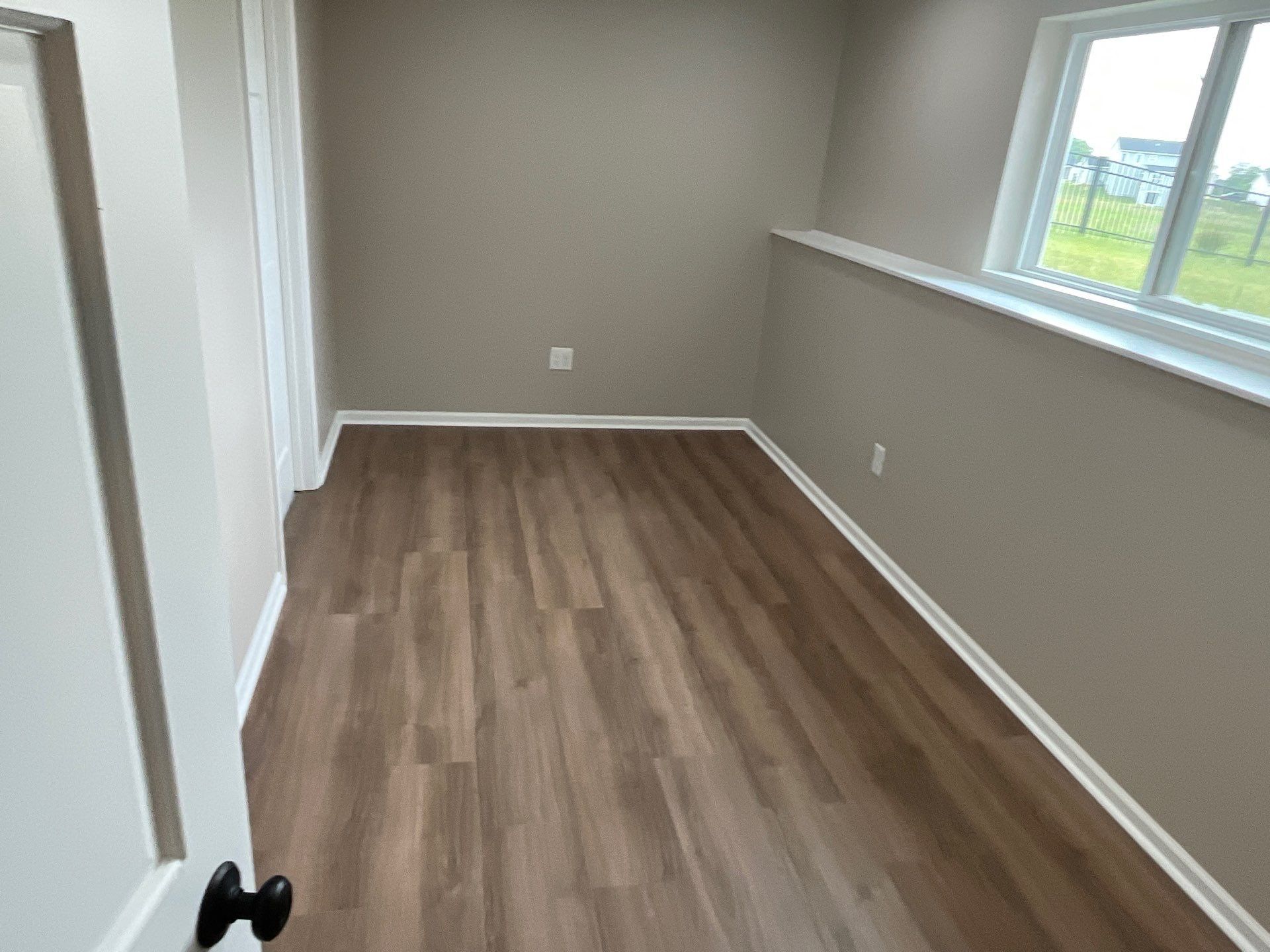 An office with new walls, fllooring, lighting and finish trim installed.