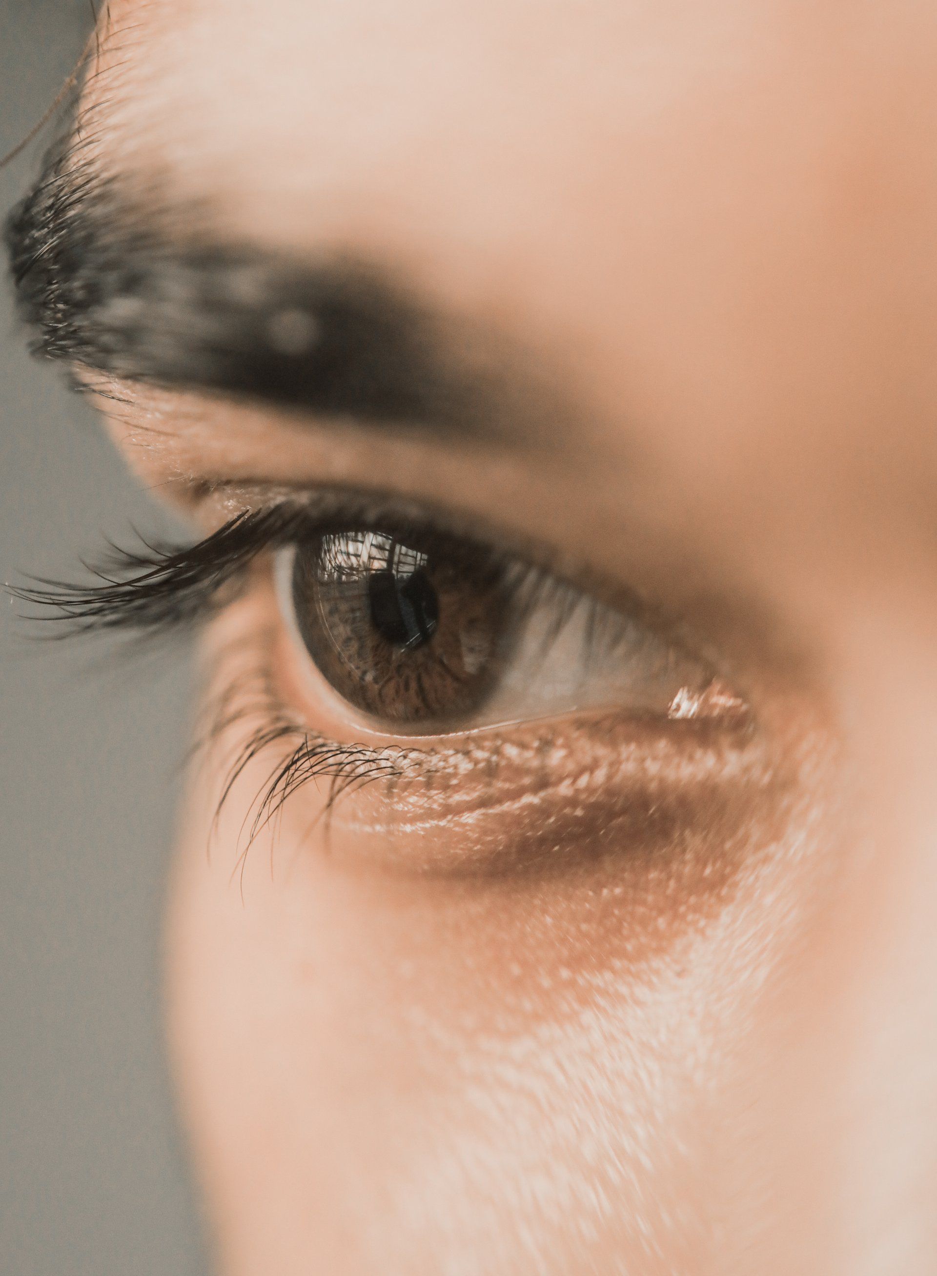 A close up of an eye with long eyelashes.